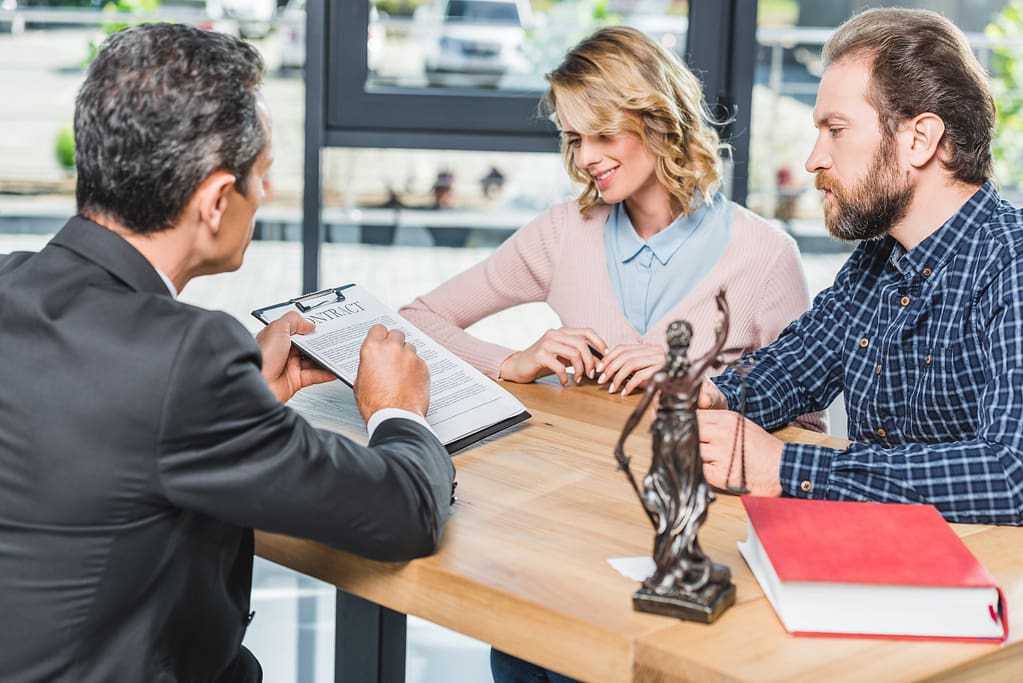 VistaCreate 174273942 stock photo couple discussing contract with lawyer scaled What Are Your Chances of Winning a Personal Injury Lawsuit? Lawyer Connection